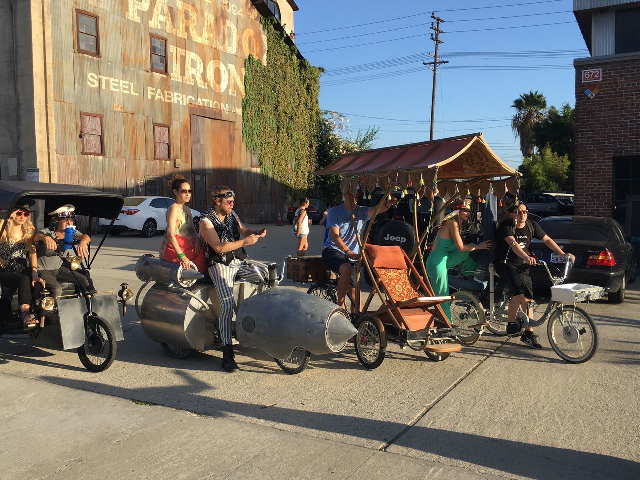 building exterior, street, transportation, architecture, land vehicle, mode of transport, built structure, bicycle, men, city, person, city life, road, car, large group of people, city street, sunlight, lifestyles, power line