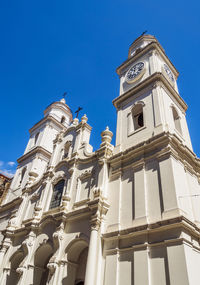 Low angle view of clock tower against sky