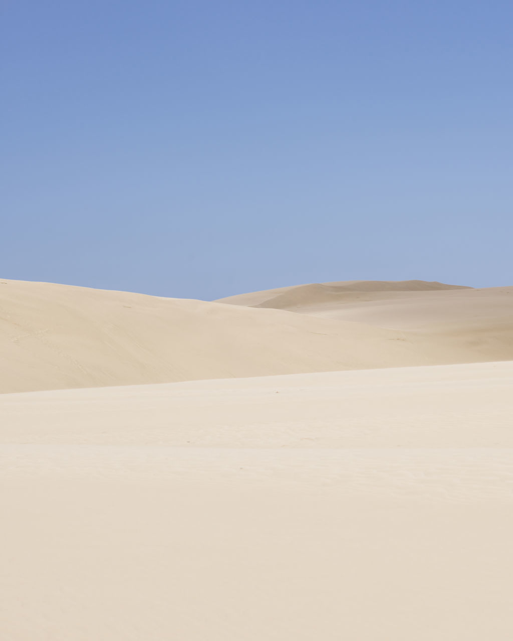 clear sky, copy space, blue, tranquility, tranquil scene, landscape, scenics, beauty in nature, nature, desert, remote, day, non-urban scene, outdoors, sand dune, horizon over land, no people, arid climate, idyllic, mountain