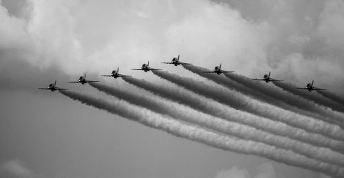 Low angle view of airshow against sky