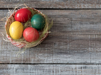 Colorful easter eggs in basket on table