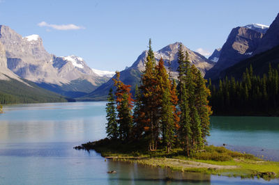 Scenic view of lake by mountains against sky