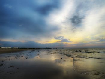 Scenic view of beach against sky during sunset