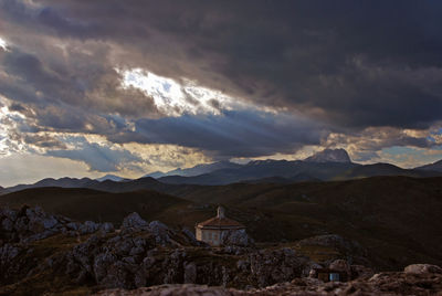 Scenic view of mountains and buildings against sky