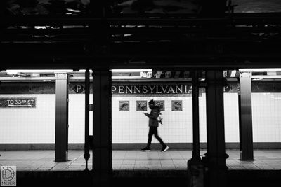 Full length of woman walking at railroad station