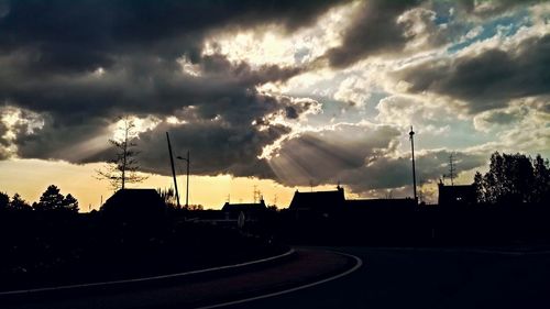 Road against cloudy sky at sunset