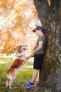 A boy and his dog looking at each other with love