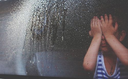 Child behind window