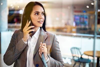 Portrait of young woman standing in store