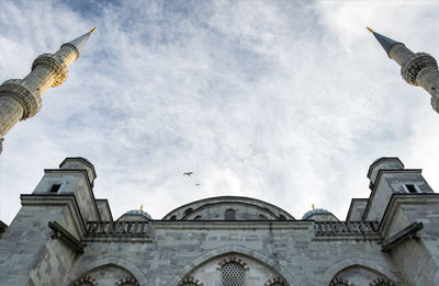 Low angle view of church against cloudy sky