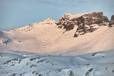 Scenic view of snow covered mountains against sky