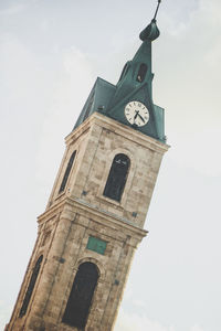 Low angle view of clock tower against sky