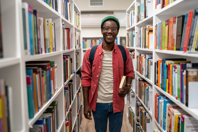 Portrait of man standing in library