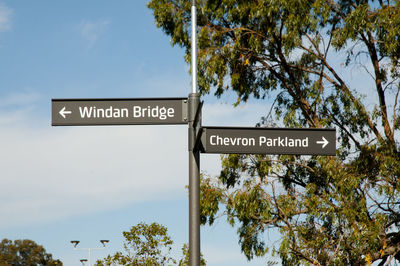 Low angle view of signboard against sky