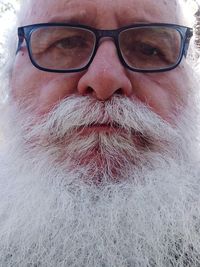 Close-up portrait of man wearing eyeglasses