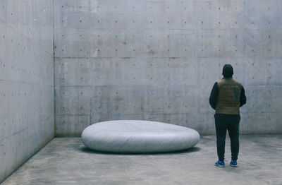 Rear view of a man standing on floor