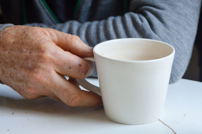 Close-up of man holding coffee cup