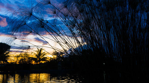 Scenic view of lake against sky at sunset