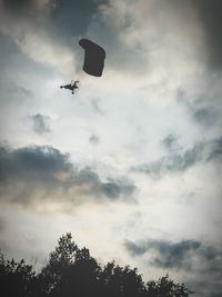 Low angle view of helicopter flying in sky