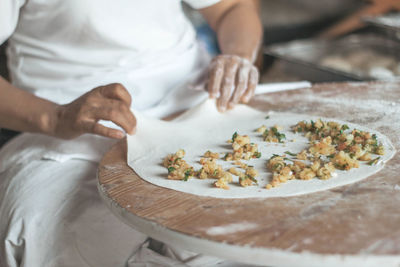 Midsection of man preparing food