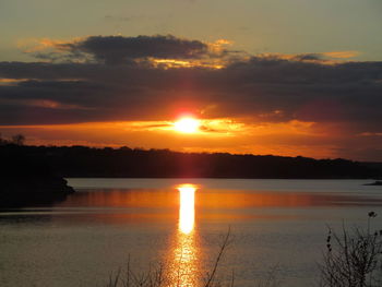 Scenic view of lake against romantic sky at sunset