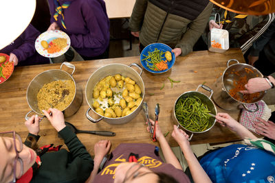 Food being served to and by a group of young people