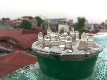 Close-up of water on table against sky in city