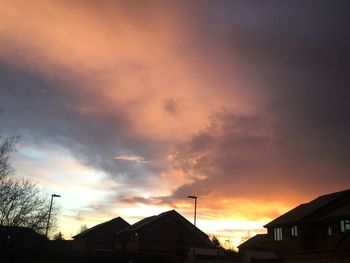 Low angle view of silhouette buildings against sky during sunset