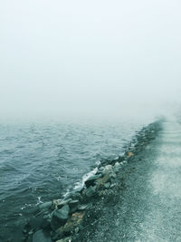 Scenic view of sea against cloudy sky