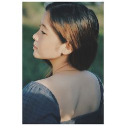 Close-up portrait of a young woman looking away