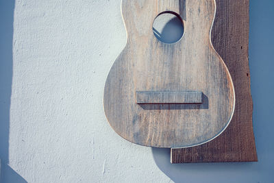 Part of guitar hanging on wall
