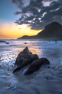 Scenic view of sea against sky at sunset