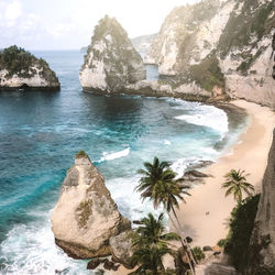 Scenic view of rock formation in sea against sky