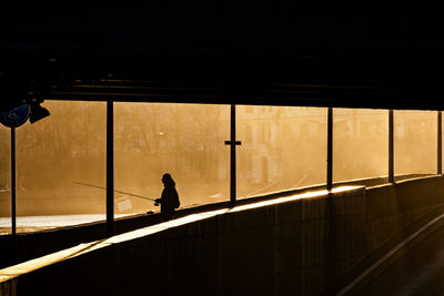 Low angle view of man standing on escalator