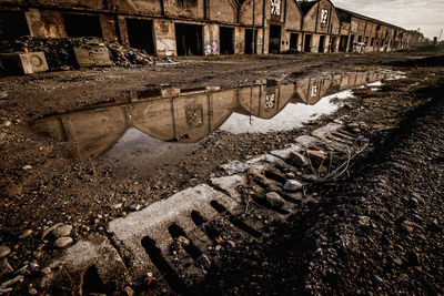 Reflection of old building in puddle