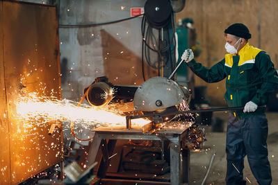 Rear view of man working in factory