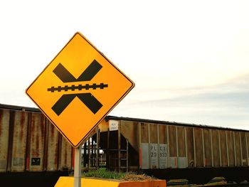 Road sign against sky