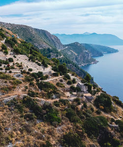 Scenic view of sea and mountains against sky