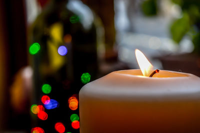 Close-up of illuminated candles on table