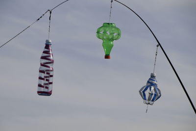 Low angle view of flags hanging against sky