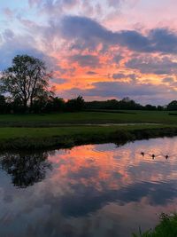 Scenic view of lake against sky during sunset