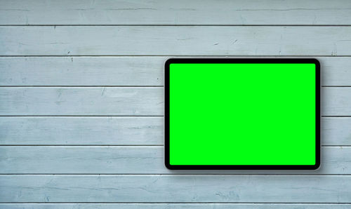 Green sign on white wall