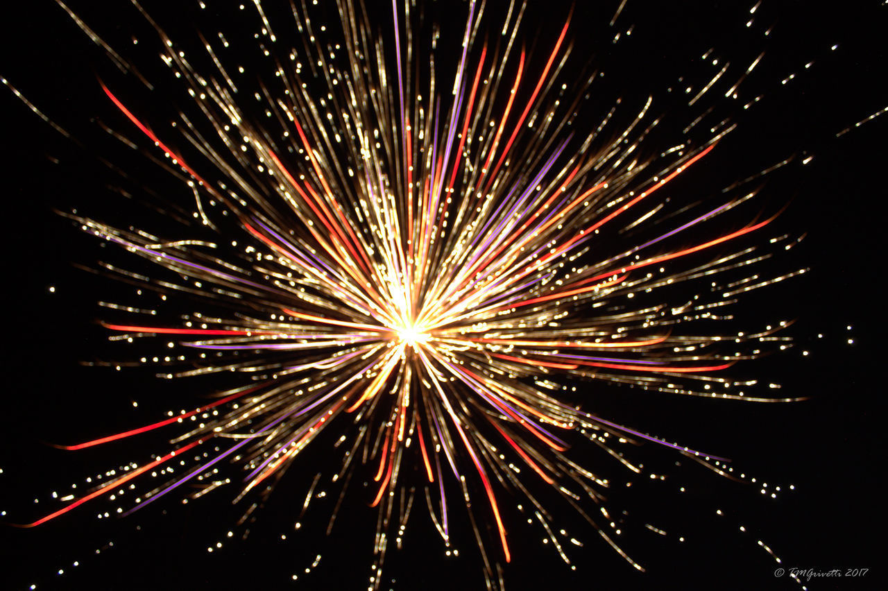 LOW ANGLE VIEW OF FIREWORKS IN SKY AT NIGHT