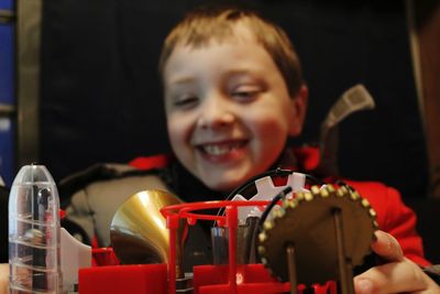 Smiling boy looking at equipment in home