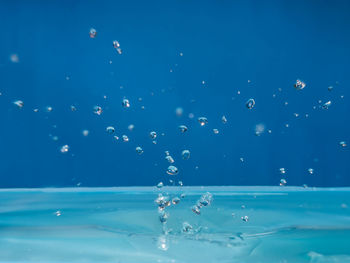 Close-up of bubbles against blue sky