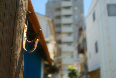 Close-up of hanging light against building