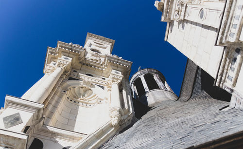 Low angle view of historical building against blue sky