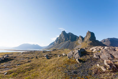 Scenic view of landscape and mountains against clear blue sky