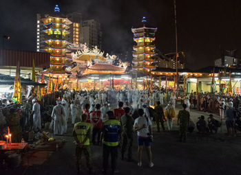 Crowd on illuminated city at night