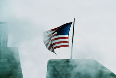 Low angle view of flag against sky